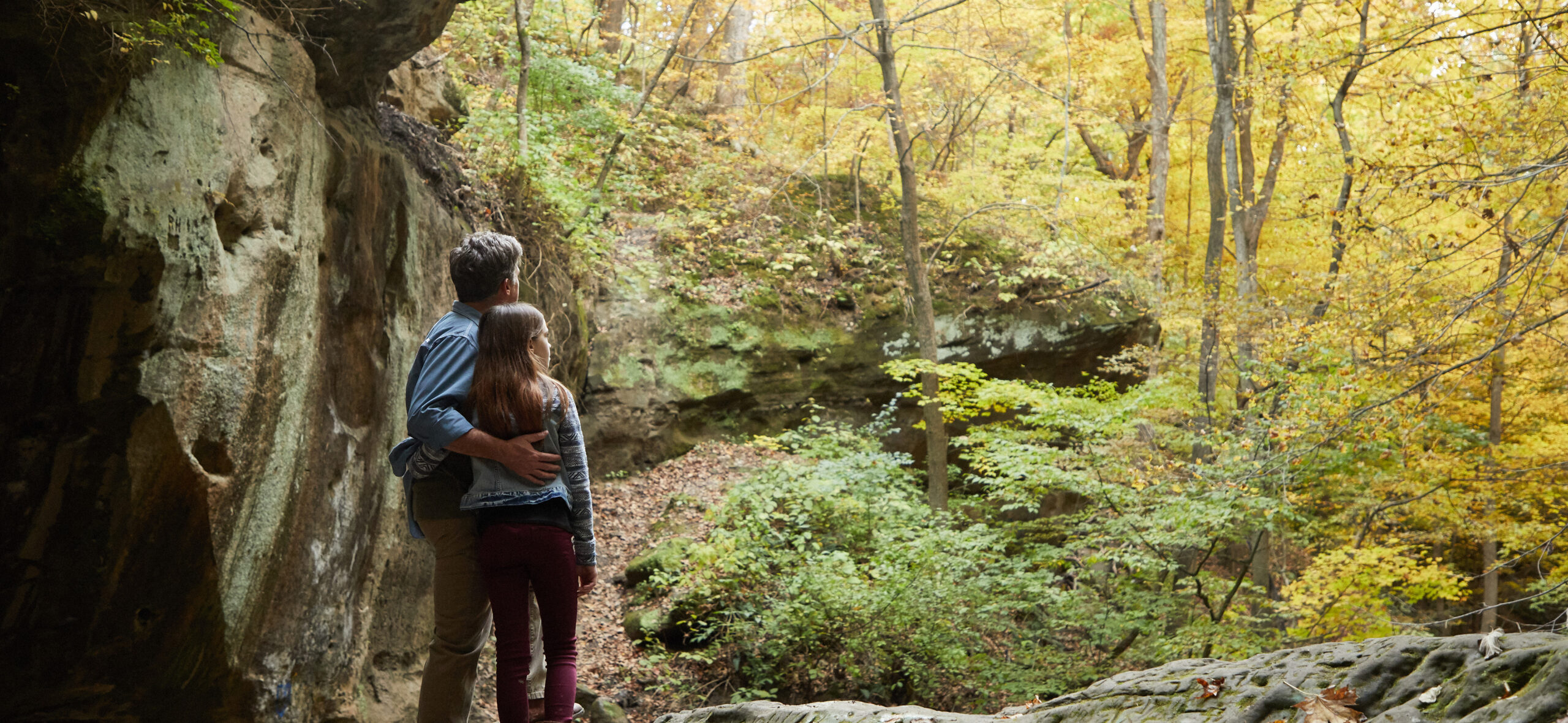 Father and daughter hiking at Rocky Glen Park in Peoria