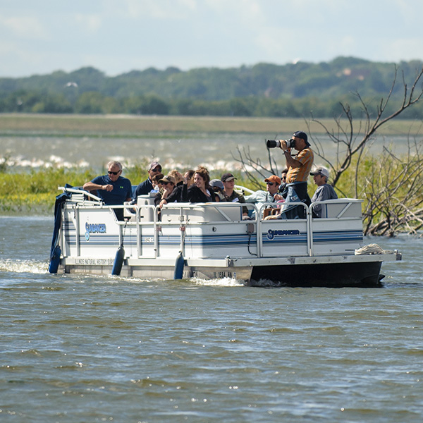 A group of visitors observing wildlife on the water at Emiquon National Wildlife Refuge.