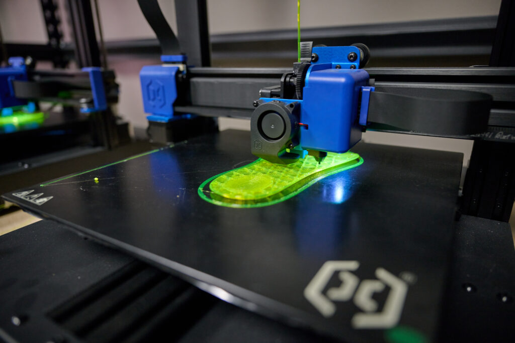 3D printer creates shoe soles.