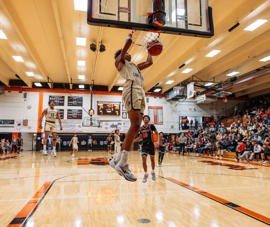 basketball player finishing a dunk