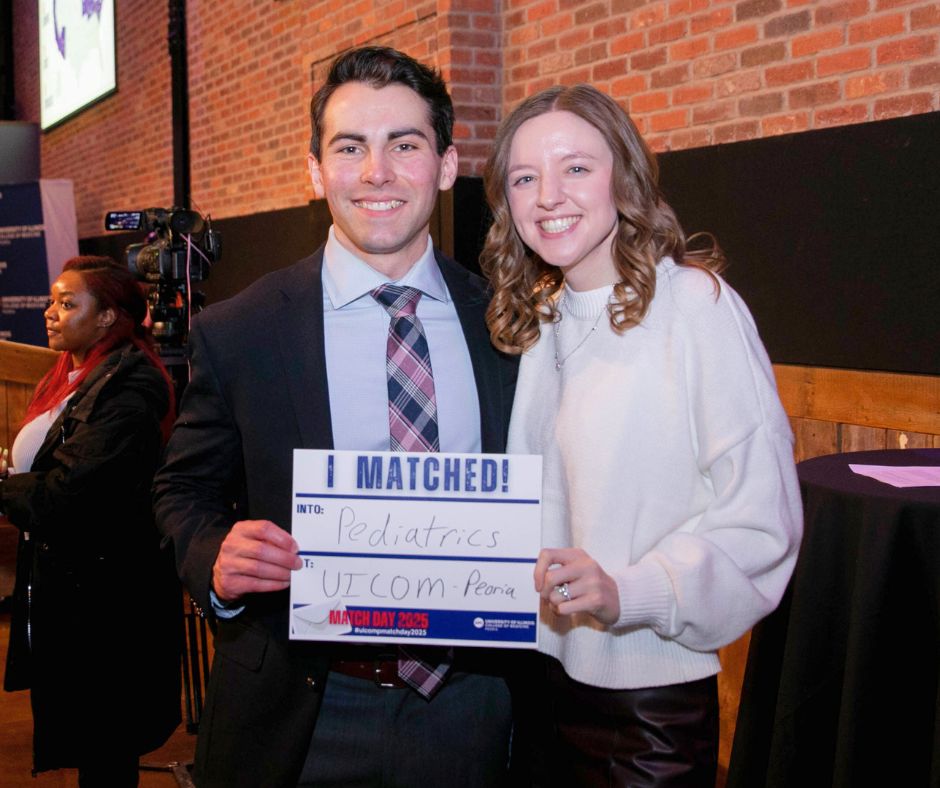 a pair of people posing for a photo on Match Day at UICOMP