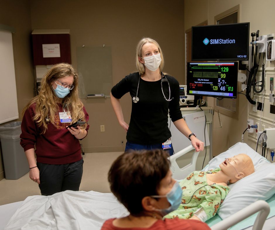 a few students participating in a simulated medical activity